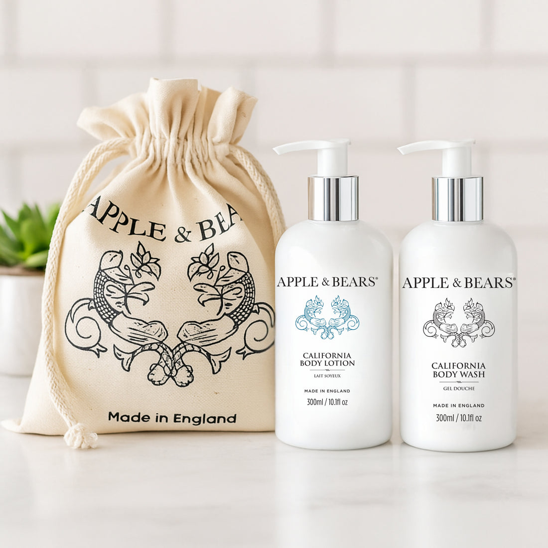 California Luxury Body Care Gift Set - Natural citrus body wash and lotion in a bright bathroom setting with signature gift bag by Apple & Bears.