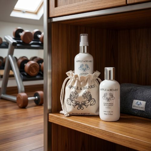 Apple & Bears California Body Wash and Lotion 100ml with eco cotton branded drawstring bag on wooden gym shelf with dumbbells - natural body care for active lifestyles