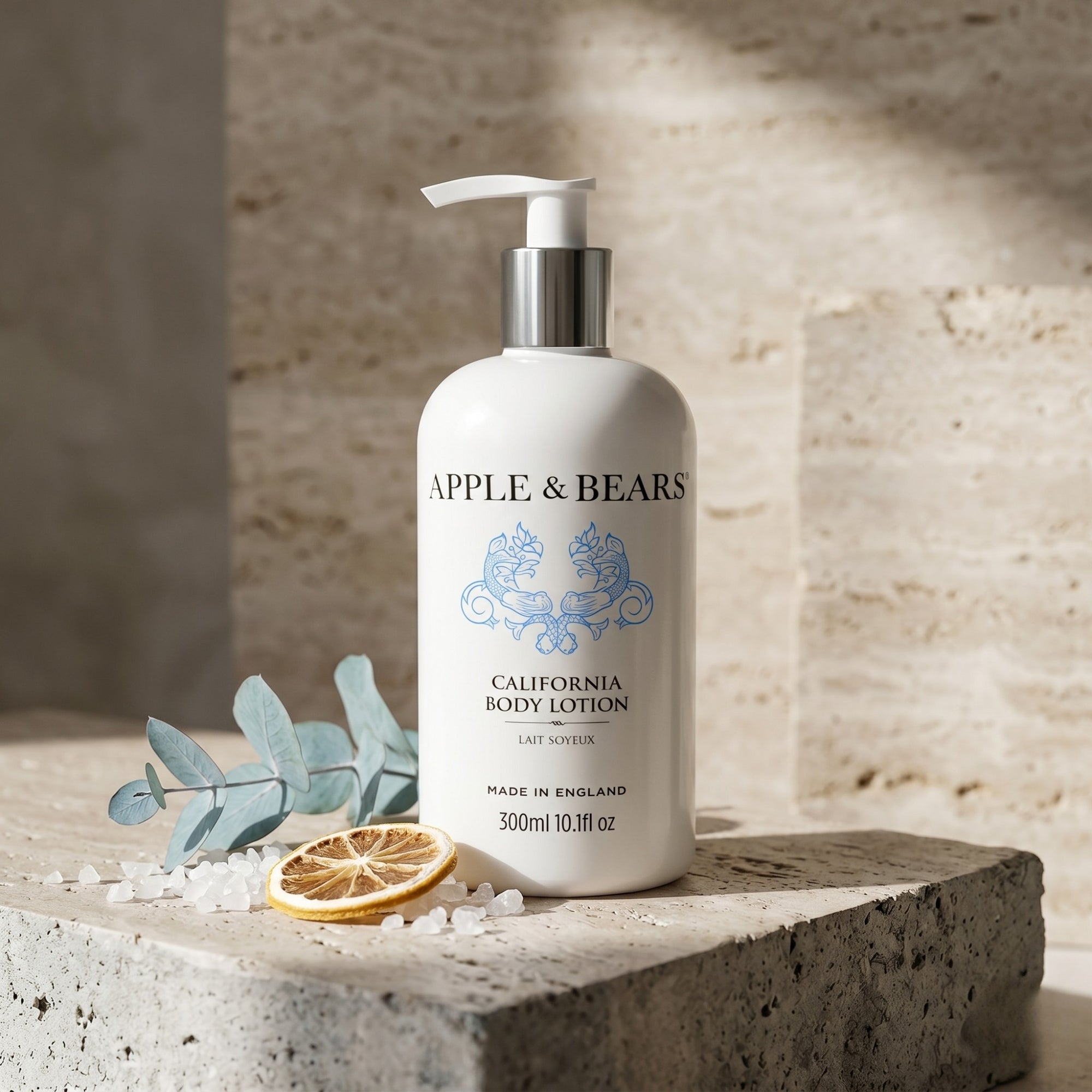 Apple and Bears California Body Lotion 300ml on stone plinth with eucalyptus lemon and sea salt Aesop editorial lifestyle made in England