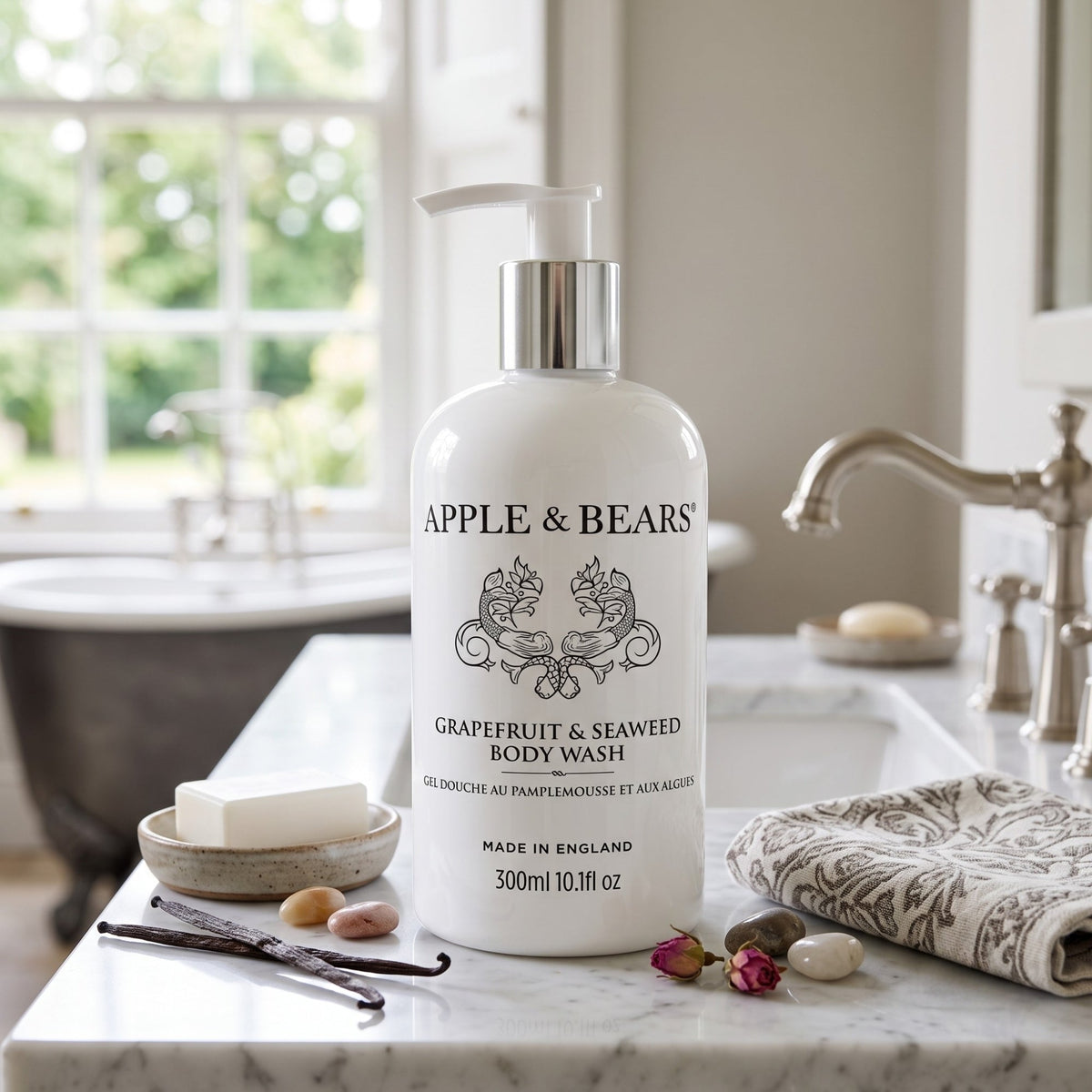 Apple & Bears Grapefruit & Seaweed Body Wash 300ml on marble bathroom counter with rose buds and vanilla pods — natural sulphate-free body wash made in England, 300ml 10.1 fl oz