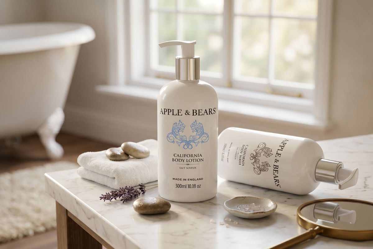 Apple & Bears California Body Lotion and Body Wash on a marble bathroom surface — premium certified organic skincare, made in England.