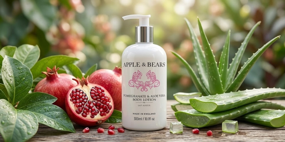 APPLE & BEARS Pomegranate & Aloe Vera Body Lotion 300ml surrounded by fresh pomegranates and aloe vera leaves — natural, botanical body lotion made in England.