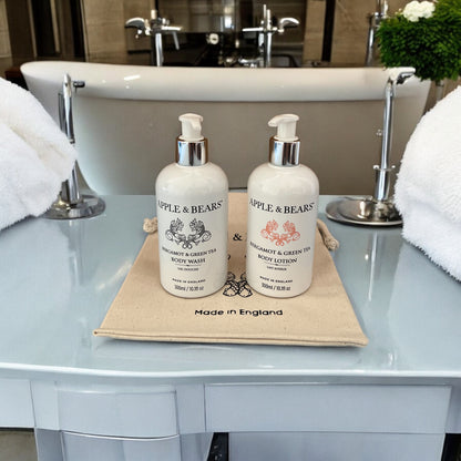 Luxury Bergamot &amp; Green Tea Body Care Set displayed in a premium bathroom setting - Natural body wash and lotion on a signature canvas bag by Apple &amp; Bears.
