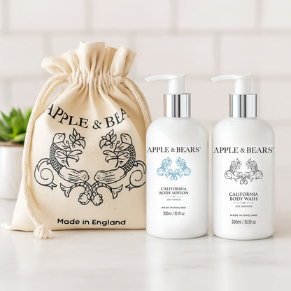 California Luxury Body Care Gift Set - Natural citrus body wash and lotion in a bright bathroom setting with signature gift bag by Apple &amp; Bears.