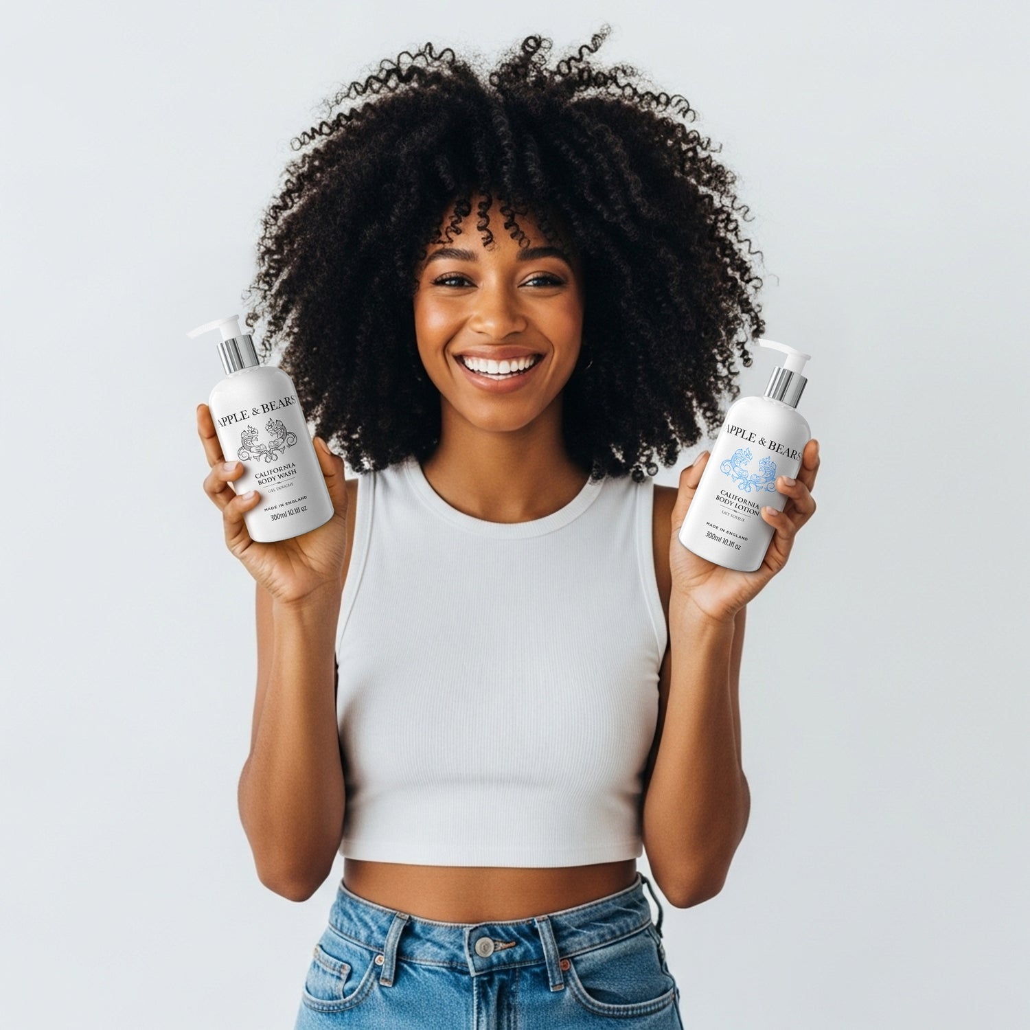 Apple &amp; Bears California Luxury Skincare Duo - Energising citrus body wash and lotion held by model, featuring natural UK-made ingredients for a zesty morning routine.