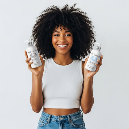 Apple &amp; Bears California Luxury Skincare Duo - Energising citrus body wash and lotion held by model, featuring natural UK-made ingredients for a zesty morning routine.