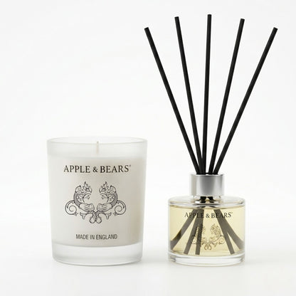 Apple &amp; Bears Sandalwood &amp; Pepper Home Gift Set featuring a 220g natural soy wax candle and a 125ml reed diffuser with black rattan reeds on a clean white background.