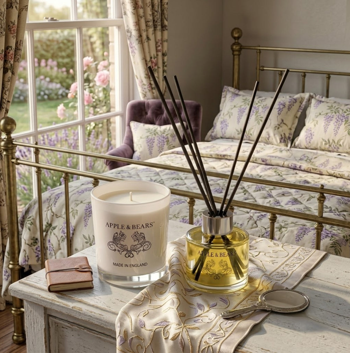 Apple &amp; Bears Jasmine Home Fragrance Gift Set with Soy Wax Candle and Reed Diffuser on a vintage painted bedside table with antique hand mirror, leather journal and wisteria floral bedding in an English country bedroom with rose garden views, Made in England