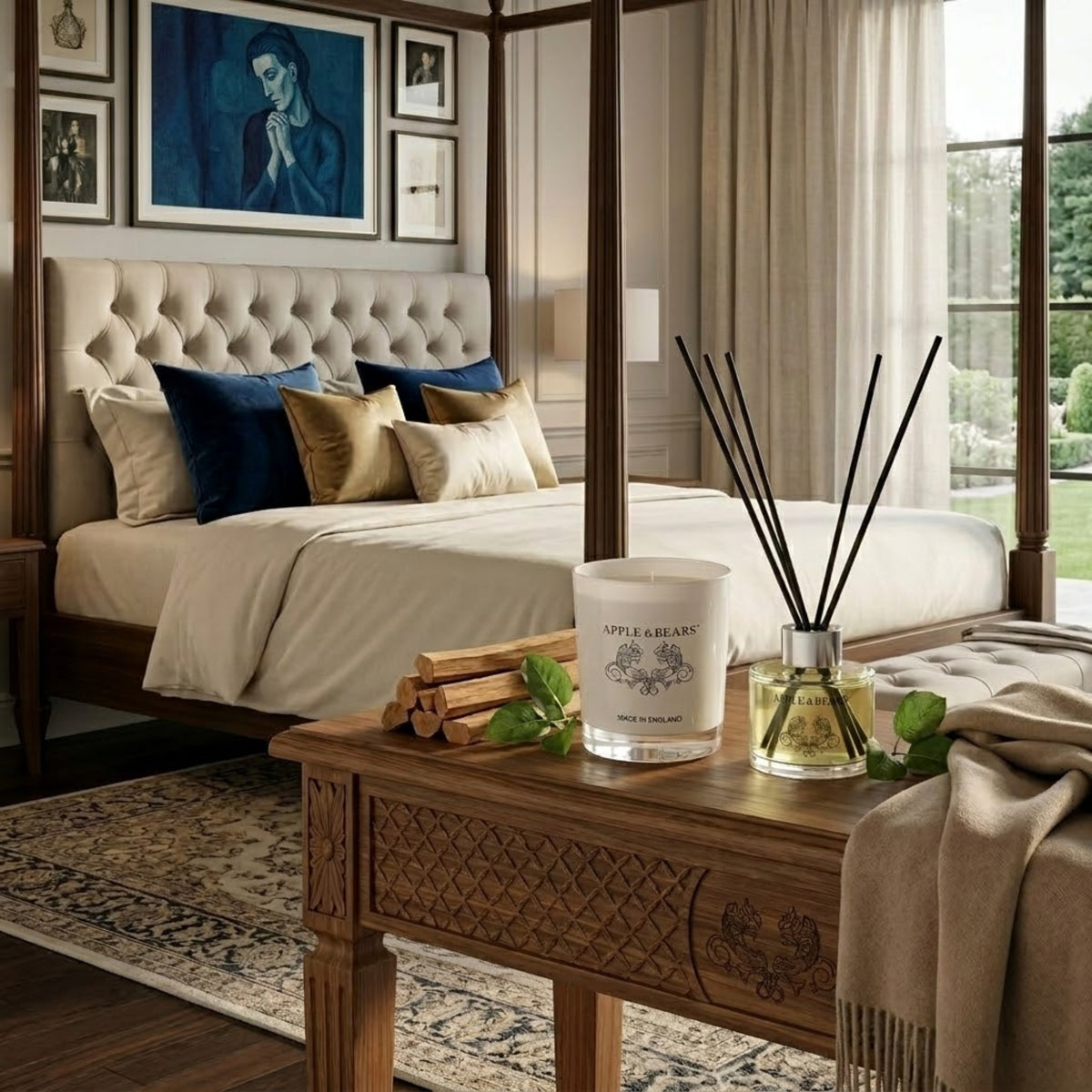 Apple &amp; Bears Sandalwood &amp; Pepper Home Fragrance Gift Set with Soy Wax Candle and Reed Diffuser on a carved oak bedside table with sandalwood sticks and fresh pepper leaves in a grand luxury bedroom with four poster bed, navy velvet cushions, Persian rug and English garden views, Made in England