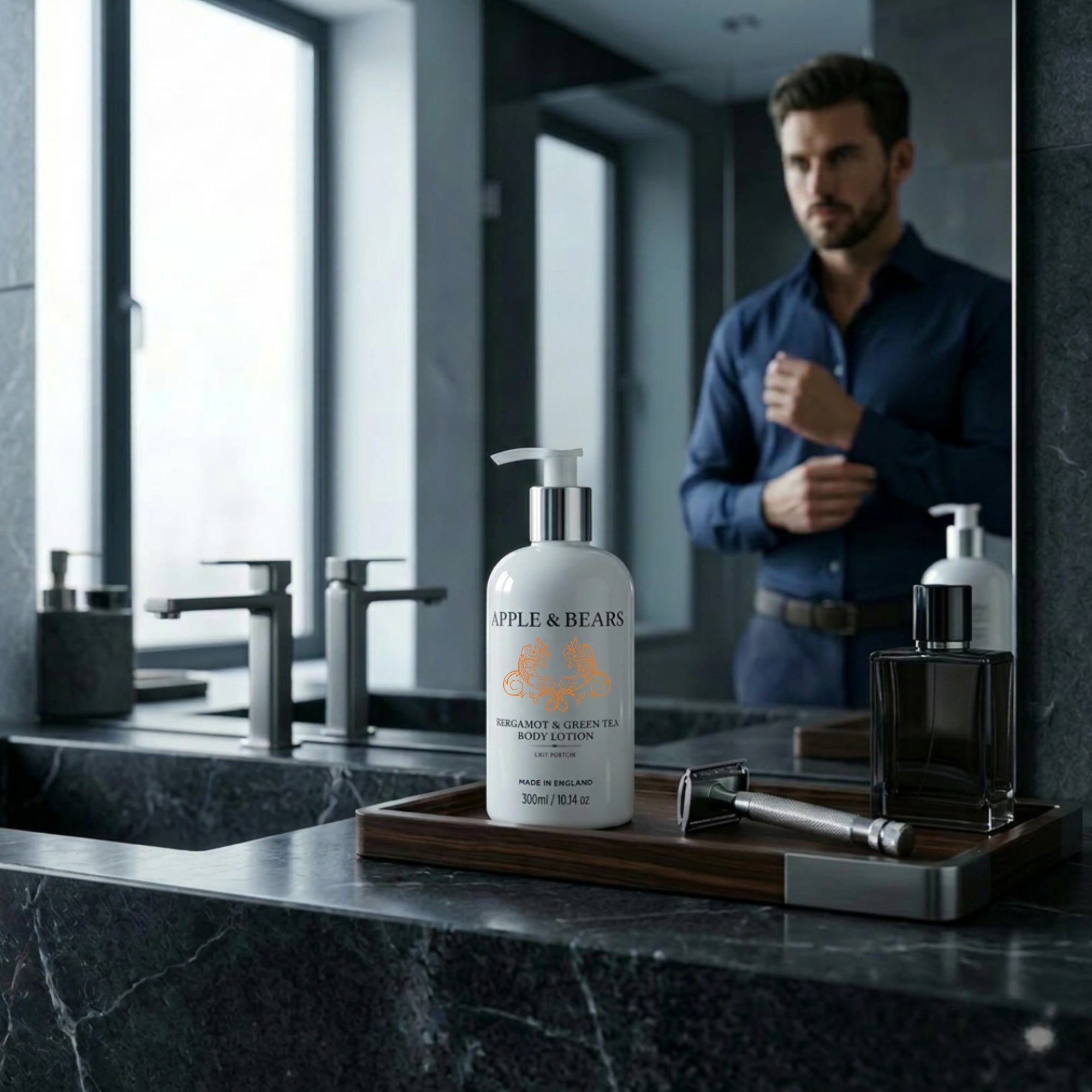 Apple &amp; Bears Bergamot &amp; Green Tea Body Lotion 300ml on dark marble bathroom counter with man adjusting shirt in mirror