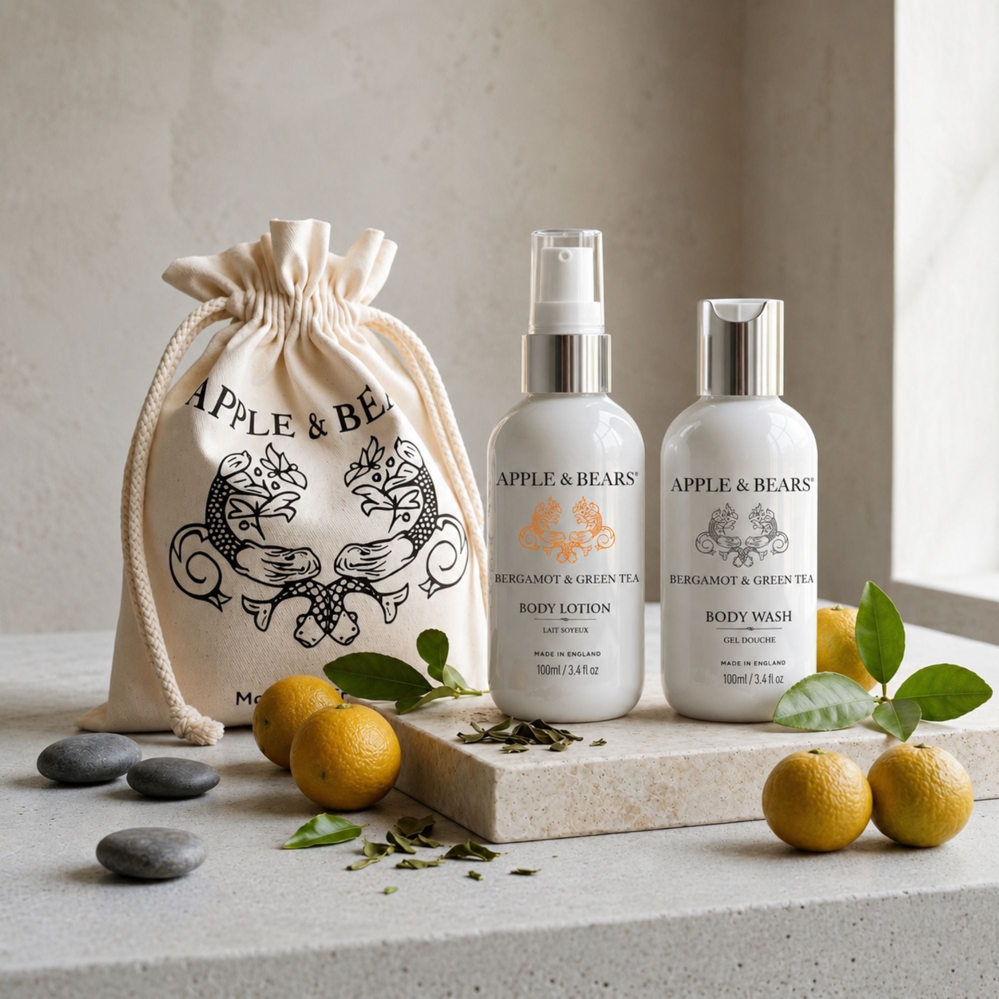 Apple &amp; Bears Bergamot &amp; Green Tea Body Lotion &amp; Body Wash Travel Gift Set 100ml/3.4 fl oz with eco cotton drawstring bag, fresh bergamot fruits and grey pebbles on travertine stone, Made in England
