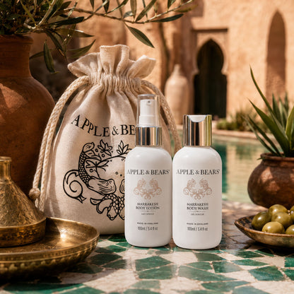 Apple &amp; Bears Marrakesh Body Lotion &amp; Body Wash Travel Gift Set 100ml/3.4 fl oz on ornate brass tray with Moroccan cushions and riad pool, Made in England