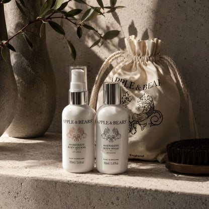 Apple &amp; Bears Marrakesh Travel Gift Set 100ml/3.4 fl oz with eco cotton drawstring bag on concrete ledge with olive branch in Moroccan riad, Made in England
